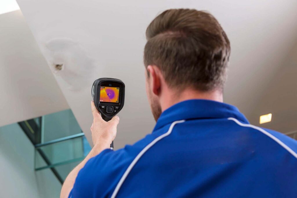 Professional plumber using thermal imaging to locate slab leaks