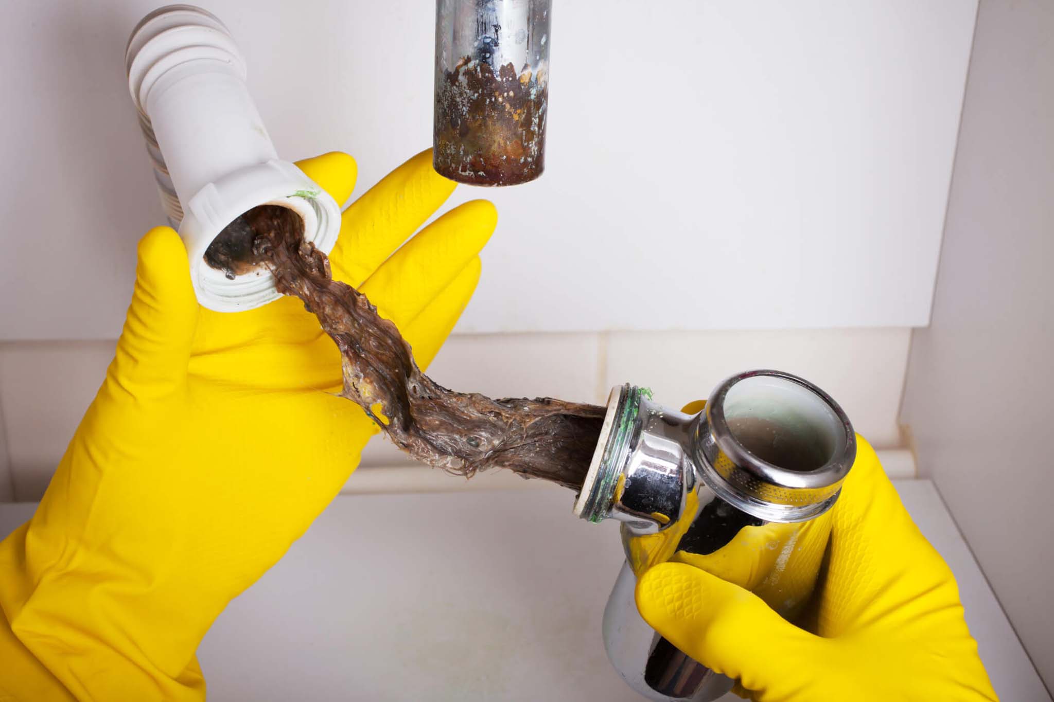 Damage caused by hair clogs in Phoenix plumbing pipes