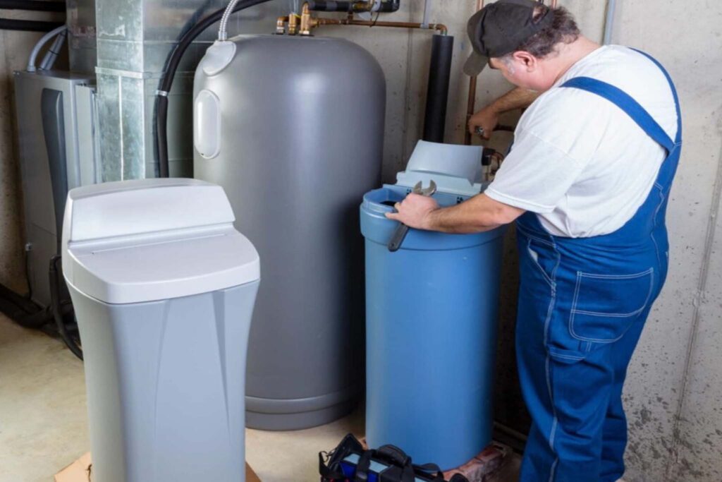 Local technician installing a water softener system in a Phoenix home