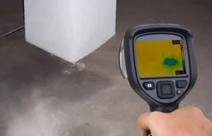 An inspection tablet displaying detailed diagnostics and line pressure analytics, held in front of a neat digital shut-off monitor interface.
