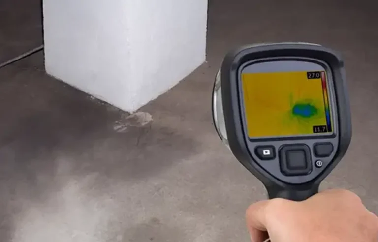 An inspection tablet displaying detailed diagnostics and line pressure analytics, held in front of a neat digital shut-off monitor interface.